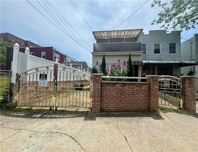 view of front of home with a fenced front yard and a gate