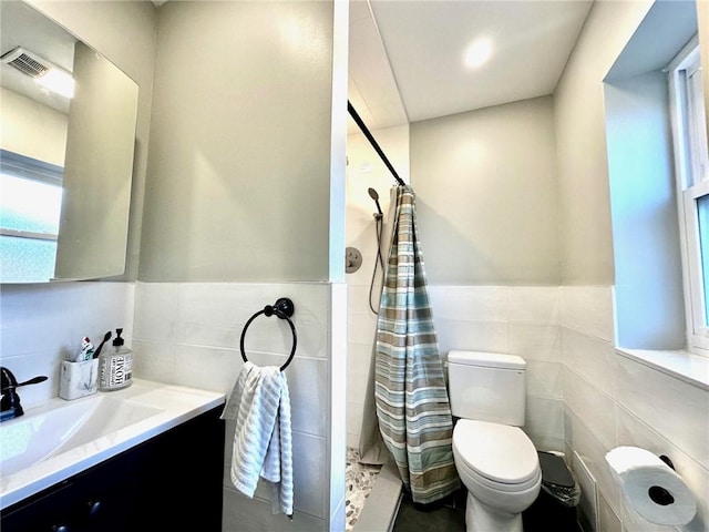 bathroom featuring vanity, tile walls, toilet, and a shower with shower curtain