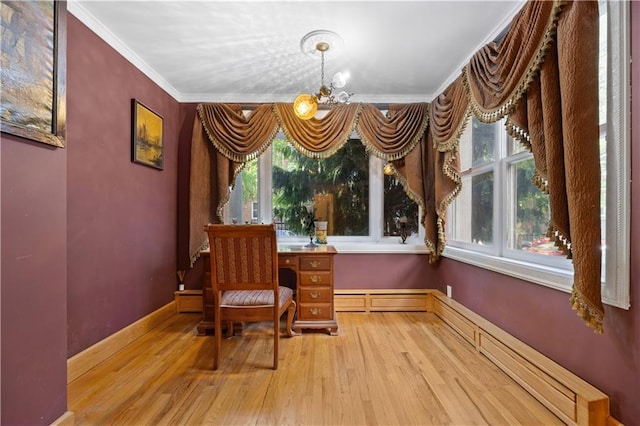 living area with crown molding, light hardwood / wood-style floors, an inviting chandelier, and a baseboard heating unit