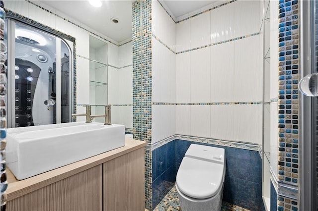 bathroom with vanity, toilet, and tile walls