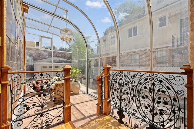 sunroom / solarium with an inviting chandelier