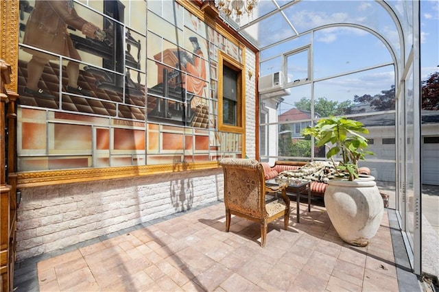 sunroom / solarium with a notable chandelier