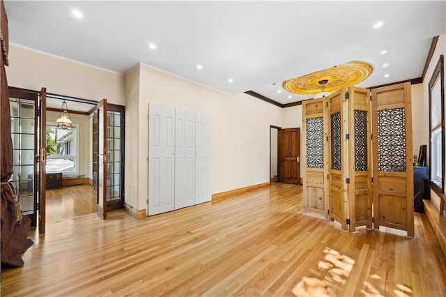 interior space with crown molding, hardwood / wood-style floors, and french doors