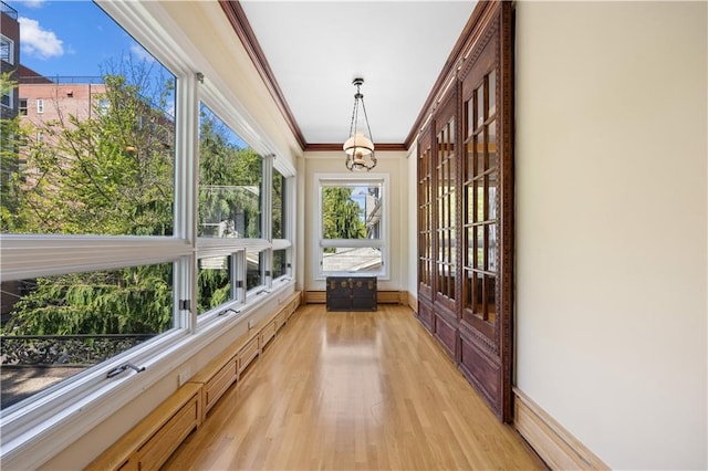 unfurnished sunroom featuring a notable chandelier