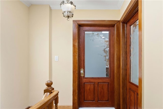 doorway to outside with crown molding