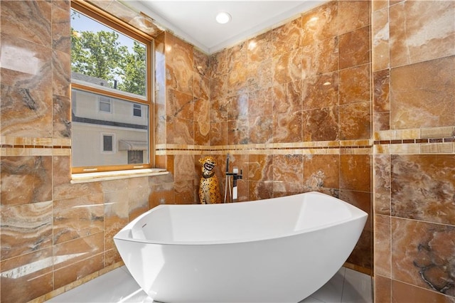 bathroom featuring a bathing tub, sink, and tile walls