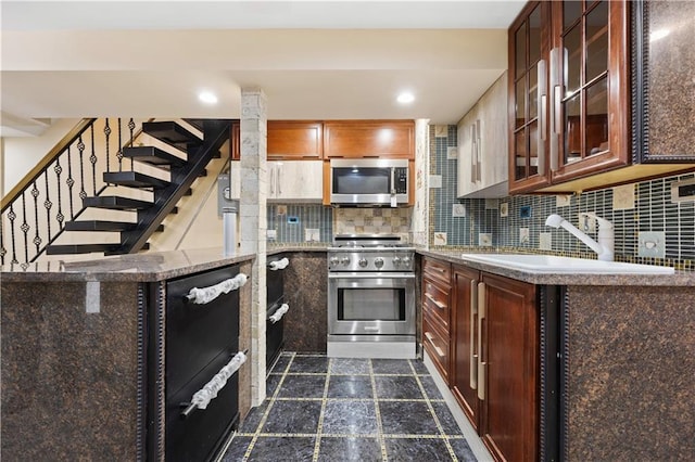 kitchen featuring tasteful backsplash, sink, and appliances with stainless steel finishes