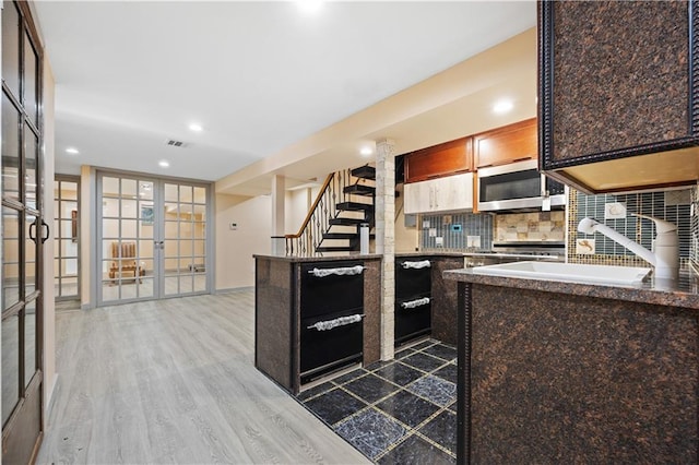 kitchen featuring french doors, sink, hardwood / wood-style floors, and tasteful backsplash