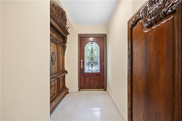 doorway to outside with light tile patterned flooring