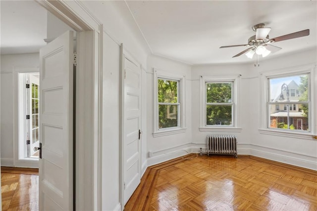 interior space featuring radiator and ceiling fan