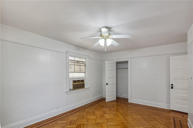 unfurnished bedroom with ceiling fan, light parquet flooring, cooling unit, and a closet