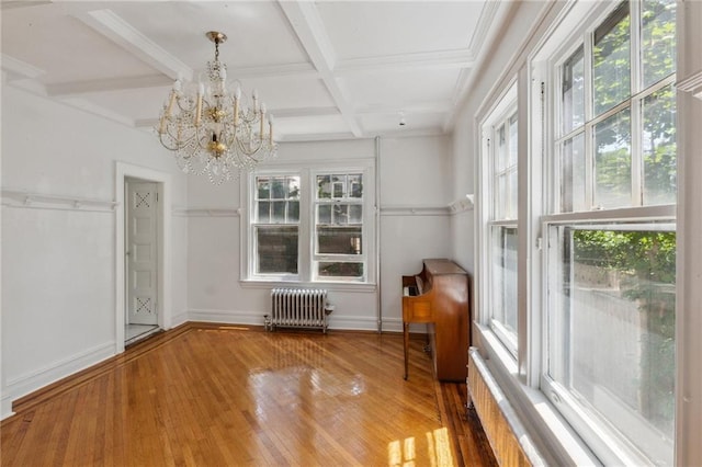 interior space featuring coffered ceiling, radiator heating unit, a chandelier, and beamed ceiling