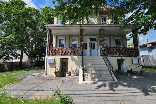 view of front of property with a wall mounted air conditioner