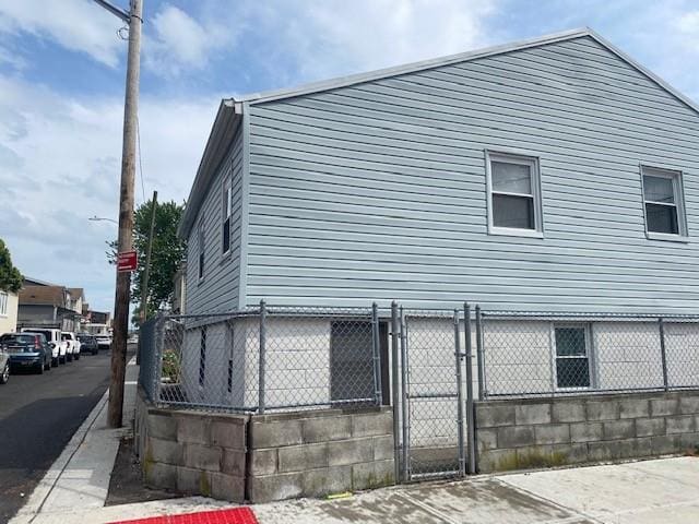 view of home's exterior with a gate and fence