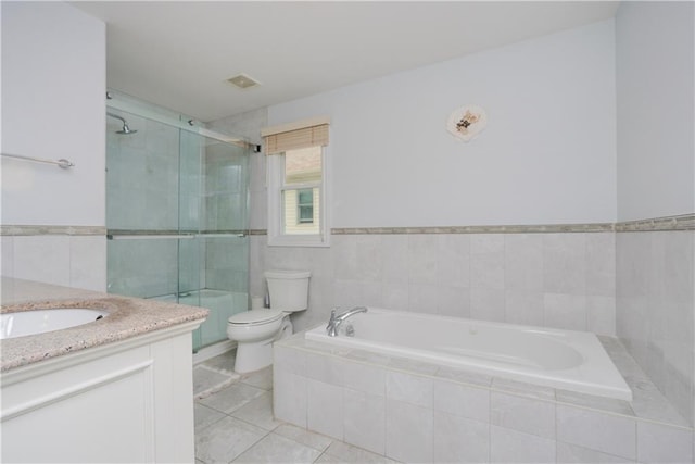 full bathroom with plus walk in shower, tile walls, tile patterned flooring, vanity, and toilet