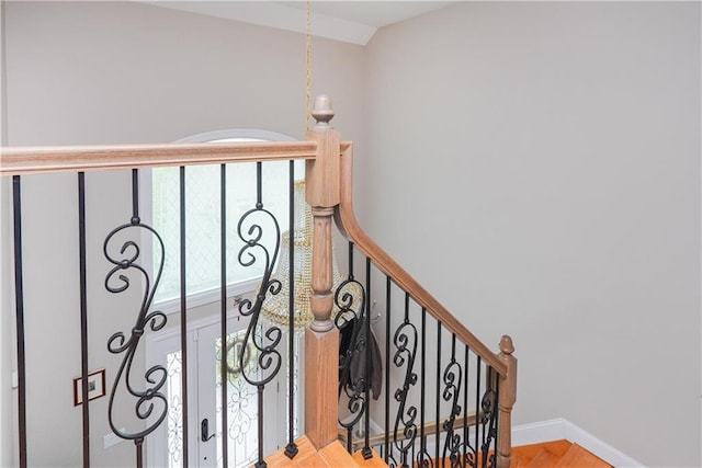 stairs with hardwood / wood-style flooring and vaulted ceiling