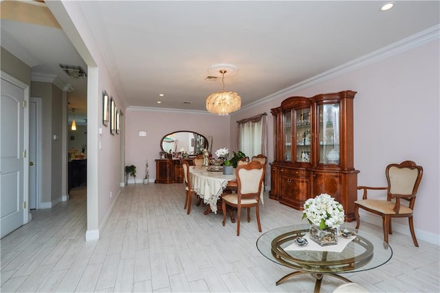 dining room with an inviting chandelier, ornamental molding, and light wood-type flooring