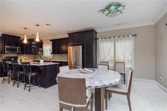 dining room with sink and crown molding