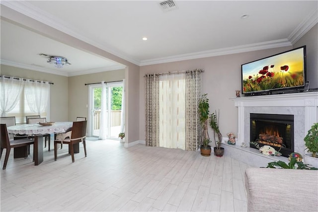 living room featuring a premium fireplace, light hardwood / wood-style flooring, and ornamental molding