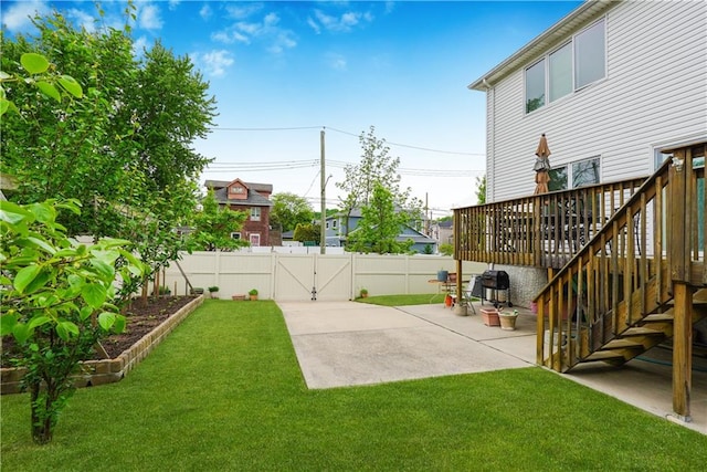 view of yard featuring a deck and a patio