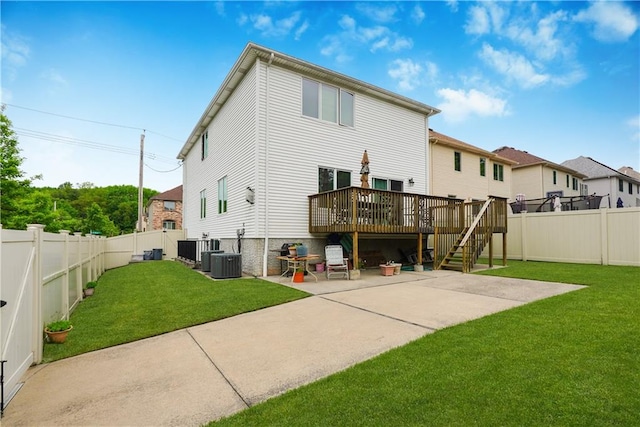 rear view of property featuring cooling unit, a patio area, a deck, and a yard