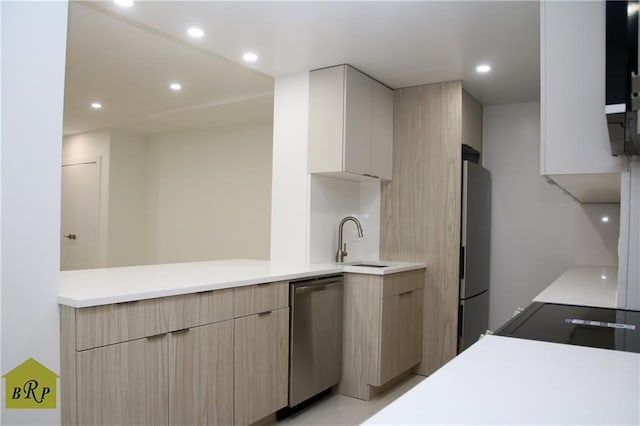 kitchen featuring stainless steel appliances, sink, and light brown cabinets