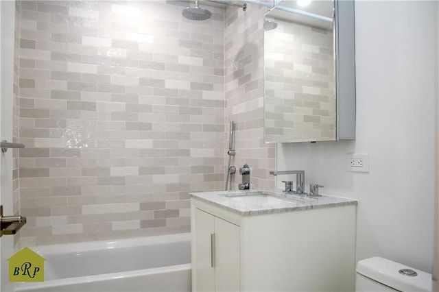 full bathroom featuring vanity, toilet, and tiled shower / bath