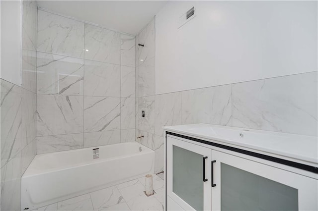 bathroom with marble finish floor, tub / shower combination, vanity, and visible vents