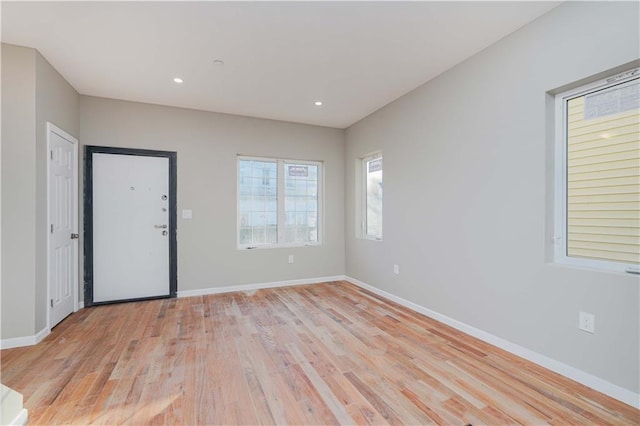 spare room with recessed lighting, light wood-style flooring, and baseboards