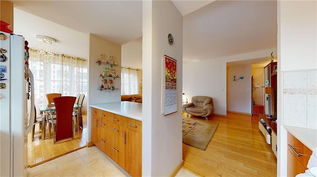 kitchen with white fridge and light hardwood / wood-style floors