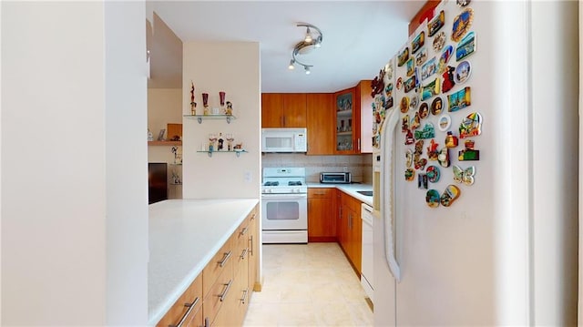 kitchen with decorative backsplash and white appliances