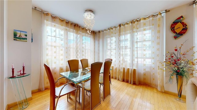 dining area with an inviting chandelier and hardwood / wood-style flooring