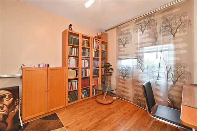 home office with light hardwood / wood-style flooring