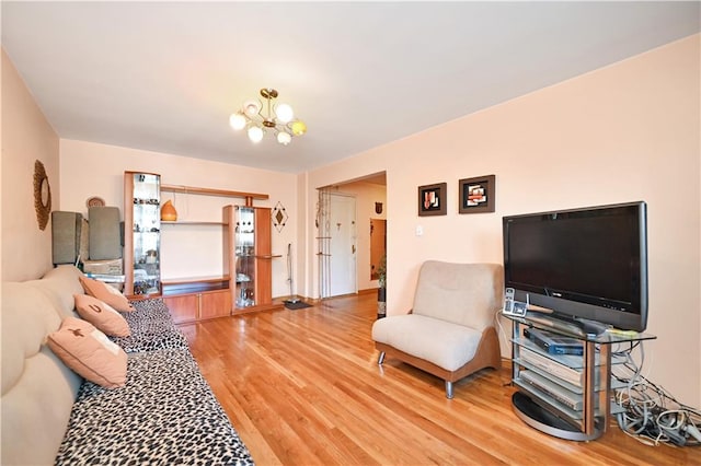 living room with an inviting chandelier and hardwood / wood-style flooring