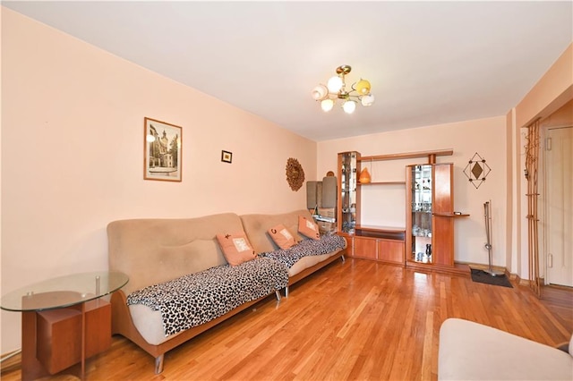 living room with a notable chandelier and light hardwood / wood-style flooring