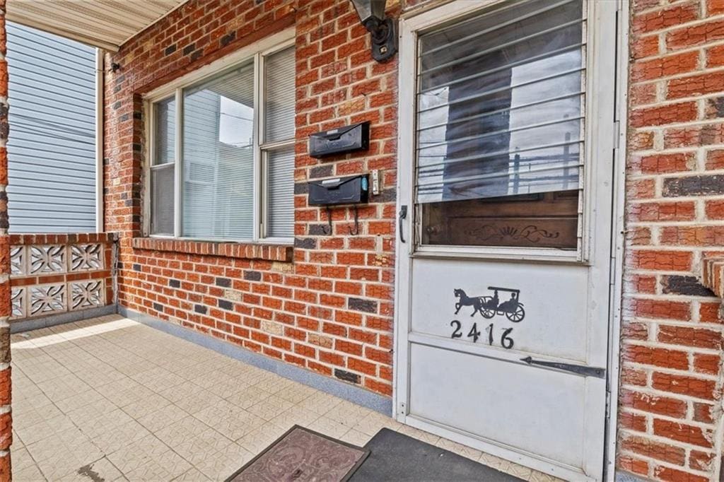 view of exterior entry featuring a porch