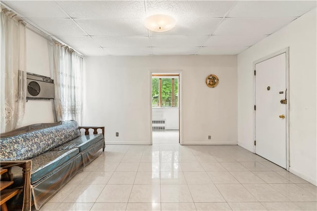 tiled foyer entrance with a drop ceiling and radiator