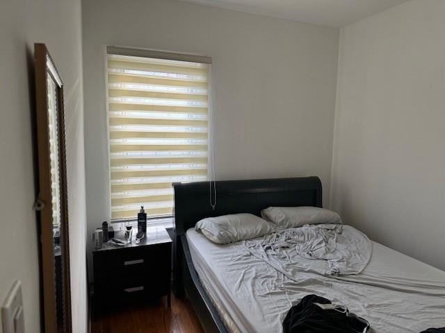 bedroom featuring dark hardwood / wood-style floors and radiator heating unit