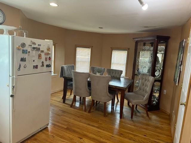 dining area featuring light wood-style flooring and recessed lighting