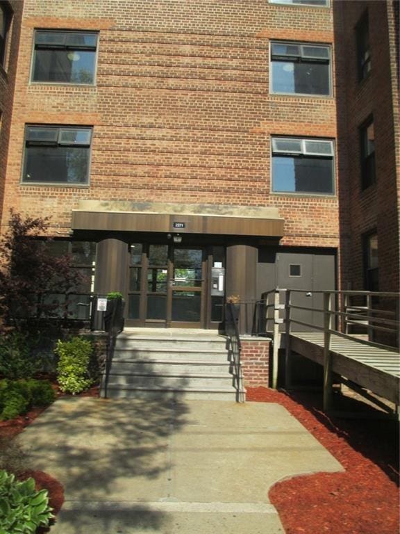 doorway to property with brick siding