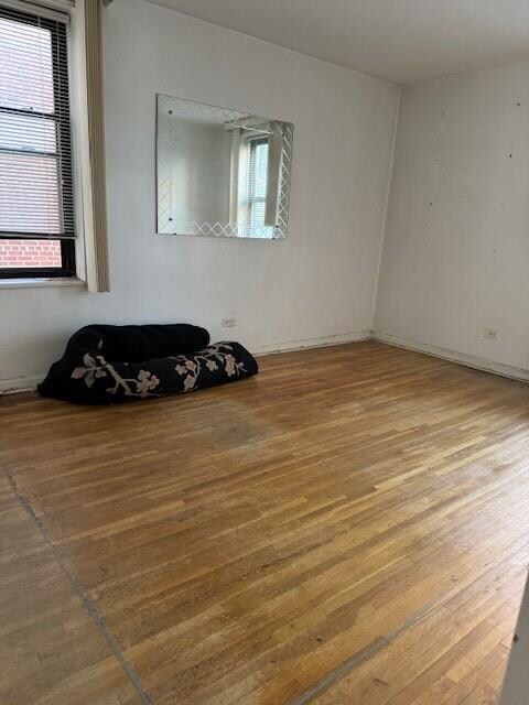 spare room with dark wood-type flooring and radiator heating unit