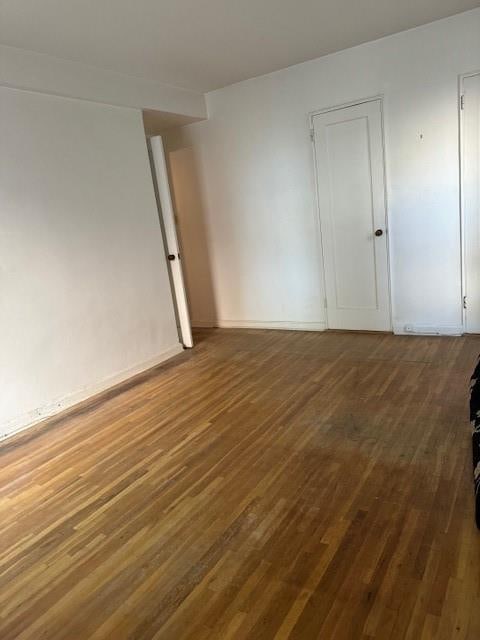 unfurnished room with wood finished floors