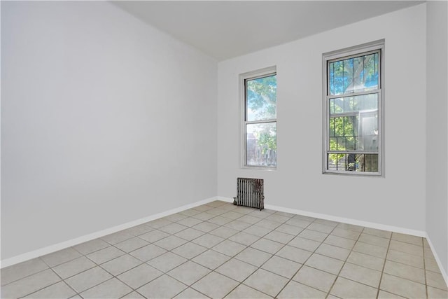 tiled empty room featuring radiator