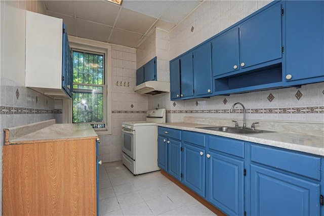 kitchen featuring white range with electric cooktop, blue cabinets, sink, and light tile patterned floors