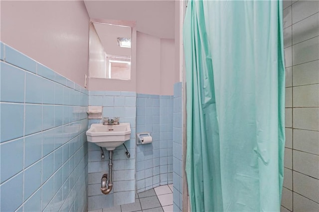 bathroom featuring tile patterned flooring, sink, tile walls, and a shower with shower curtain