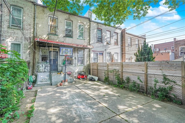 rear view of property featuring a patio area