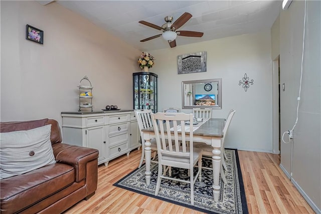 dining area with ceiling fan and light hardwood / wood-style flooring