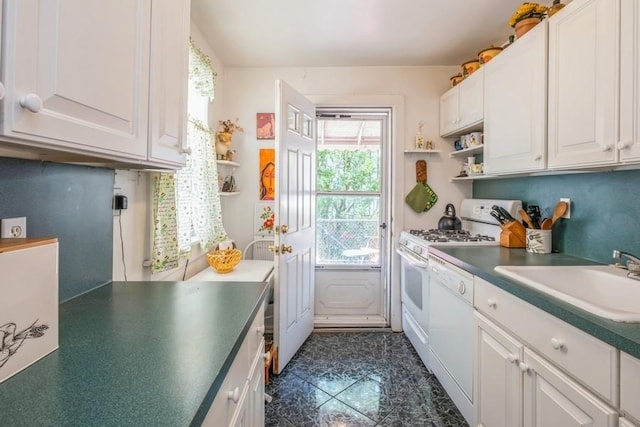 kitchen with white appliances, sink, and white cabinets