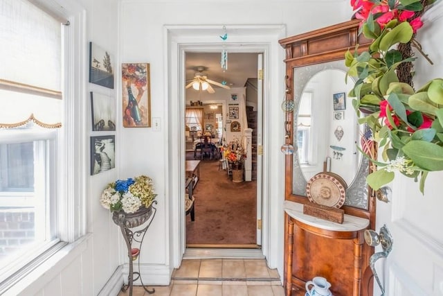 entryway with ceiling fan and light tile patterned floors