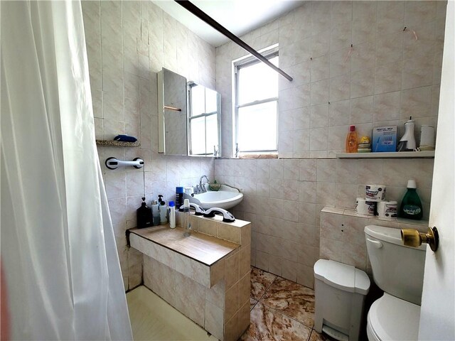 6525 Avenue N, Brooklyn, NY 11234 - full bathroom featuring tile walls, toilet, a tile shower, and a sink